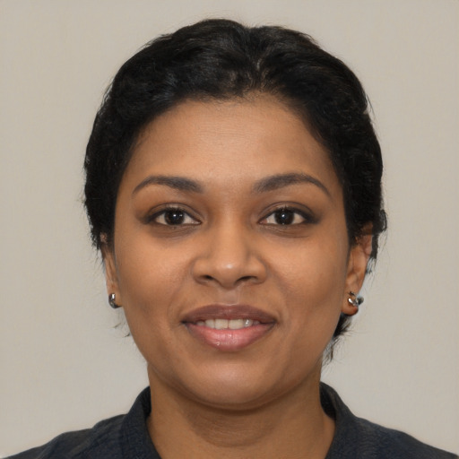 Joyful latino young-adult female with short  black hair and brown eyes