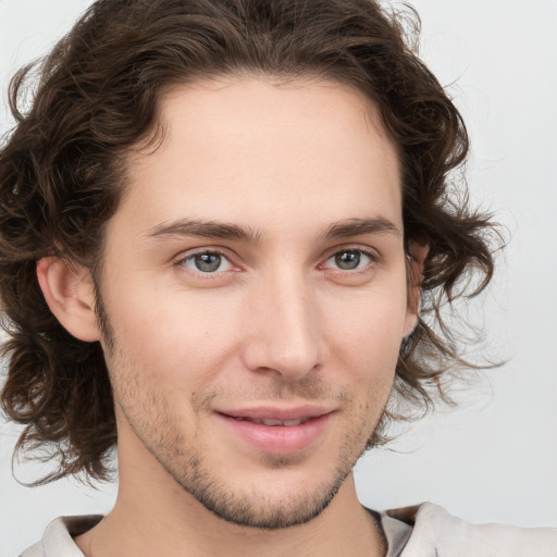 Joyful white young-adult male with medium  brown hair and brown eyes