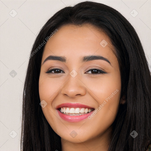 Joyful latino young-adult female with long  black hair and brown eyes