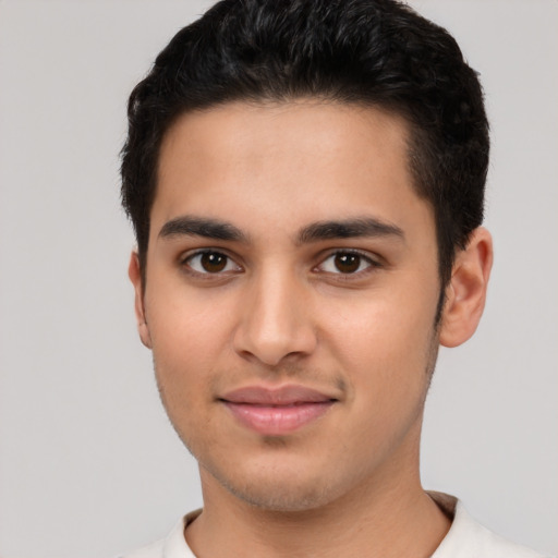 Joyful white young-adult male with short  black hair and brown eyes