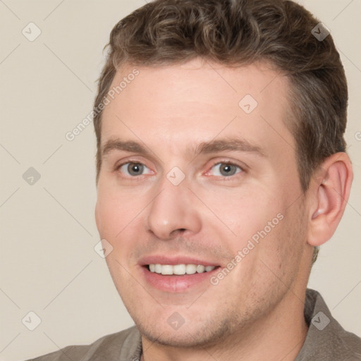 Joyful white adult male with short  brown hair and brown eyes