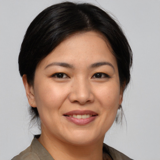 Joyful asian adult female with medium  brown hair and brown eyes