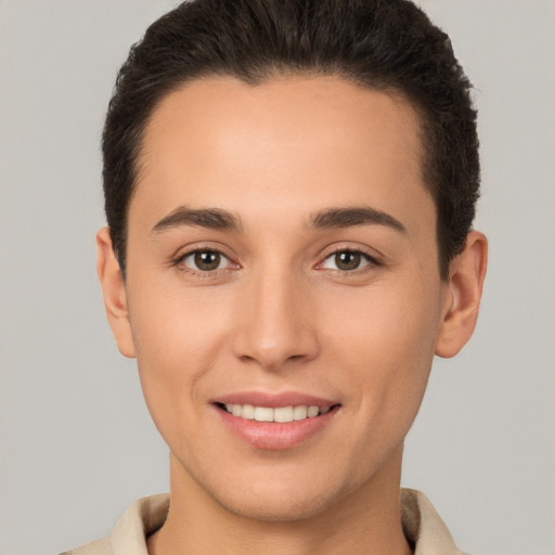 Joyful white young-adult male with short  brown hair and brown eyes