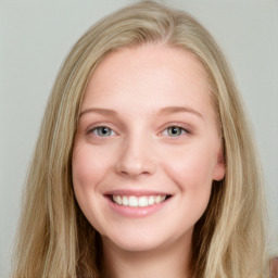 Joyful white young-adult female with long  brown hair and blue eyes