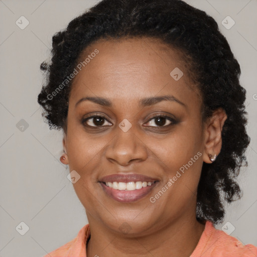 Joyful black adult female with medium  brown hair and brown eyes