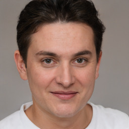 Joyful white young-adult male with short  brown hair and brown eyes