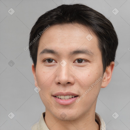 Joyful asian young-adult male with short  brown hair and brown eyes