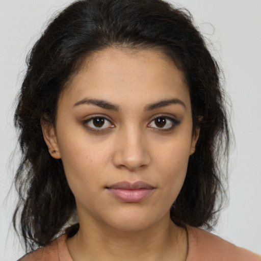 Joyful latino young-adult female with medium  brown hair and brown eyes