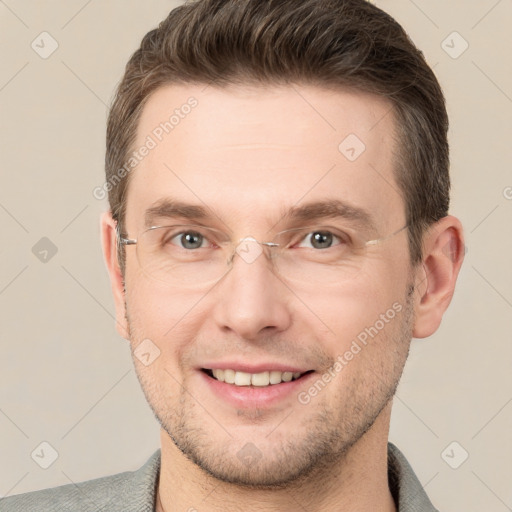 Joyful white adult male with short  brown hair and grey eyes