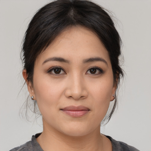 Joyful asian young-adult female with medium  black hair and brown eyes