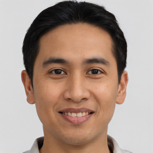 Joyful asian young-adult male with short  black hair and brown eyes