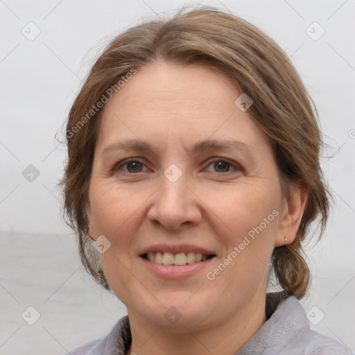 Joyful white adult female with medium  brown hair and brown eyes