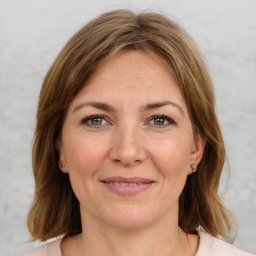 Joyful white adult female with medium  brown hair and brown eyes