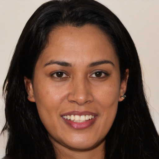 Joyful latino young-adult female with long  brown hair and brown eyes