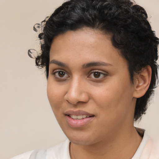 Joyful latino young-adult female with short  brown hair and brown eyes