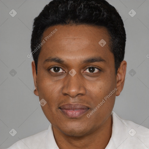 Joyful black young-adult male with short  black hair and brown eyes