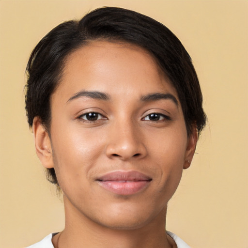 Joyful latino young-adult female with short  brown hair and brown eyes