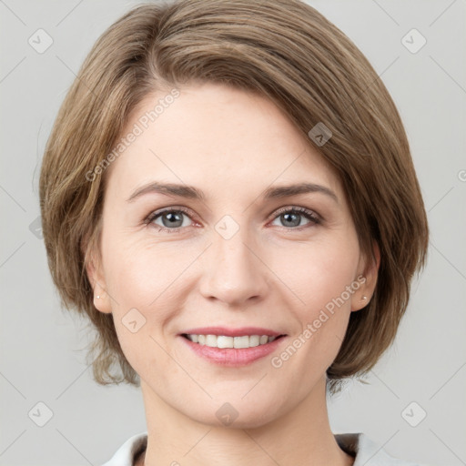 Joyful white young-adult female with medium  brown hair and green eyes