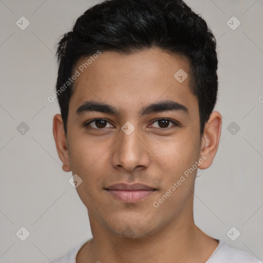 Joyful latino young-adult male with short  black hair and brown eyes