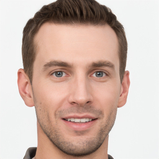 Joyful white young-adult male with short  brown hair and grey eyes