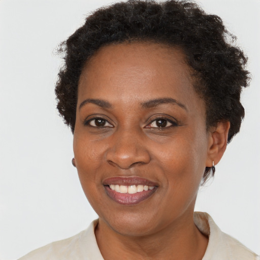 Joyful black adult female with short  brown hair and brown eyes