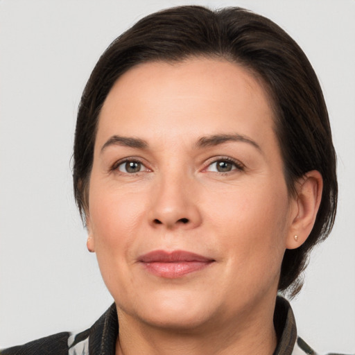 Joyful white adult female with medium  brown hair and brown eyes