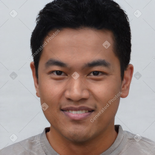 Joyful white young-adult male with short  black hair and brown eyes