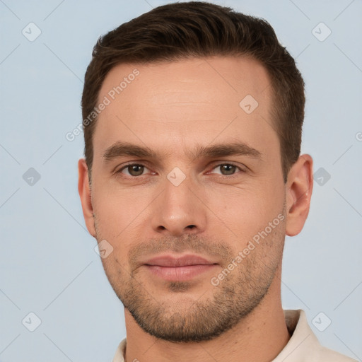 Joyful white young-adult male with short  brown hair and brown eyes