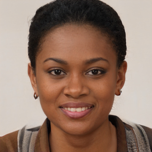 Joyful black young-adult female with short  brown hair and brown eyes