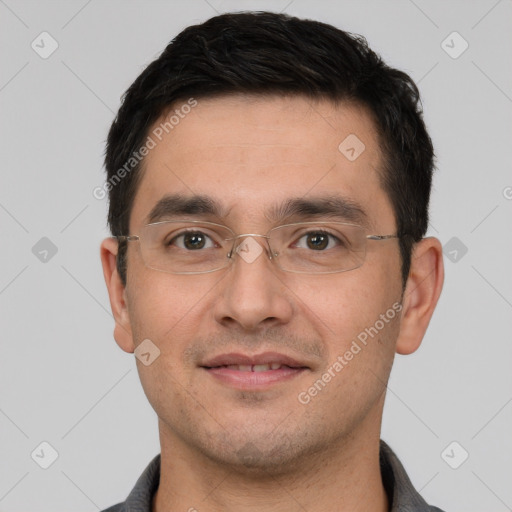 Joyful white young-adult male with short  black hair and brown eyes