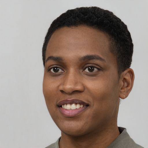 Joyful black young-adult female with short  black hair and brown eyes