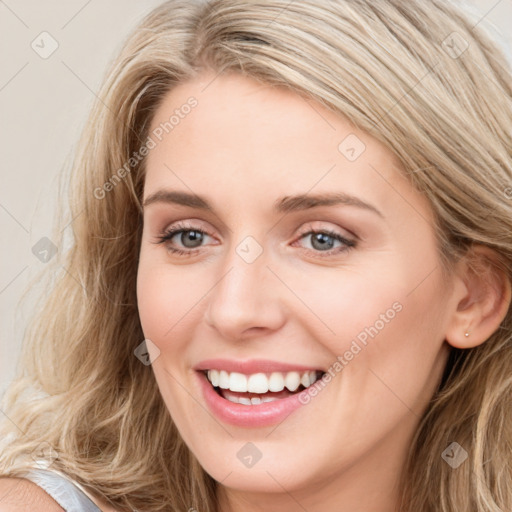 Joyful white young-adult female with long  brown hair and blue eyes