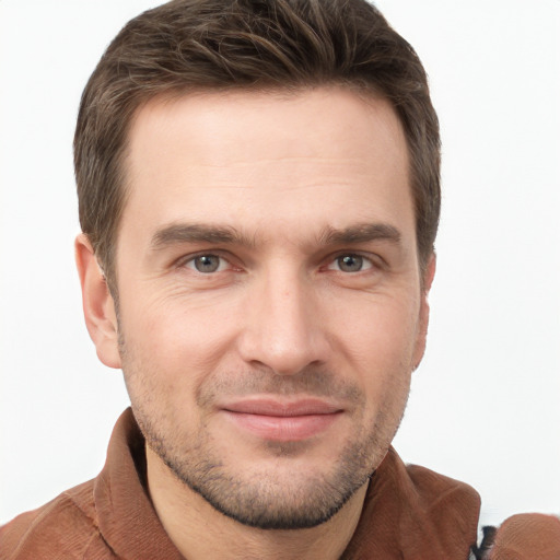 Joyful white young-adult male with short  brown hair and grey eyes