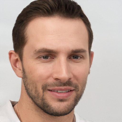 Joyful white young-adult male with short  brown hair and brown eyes