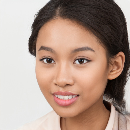 Joyful latino young-adult female with long  brown hair and brown eyes