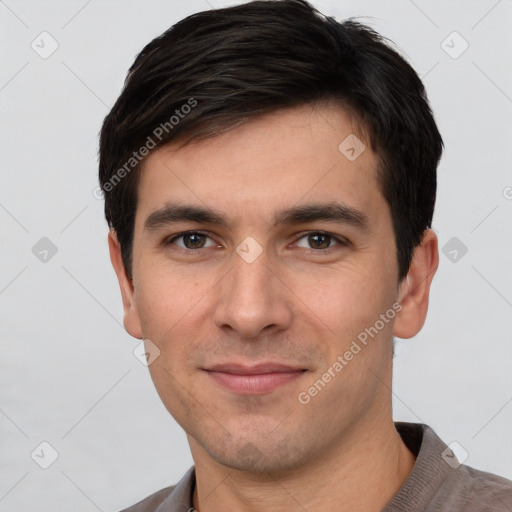 Joyful white young-adult male with short  brown hair and brown eyes