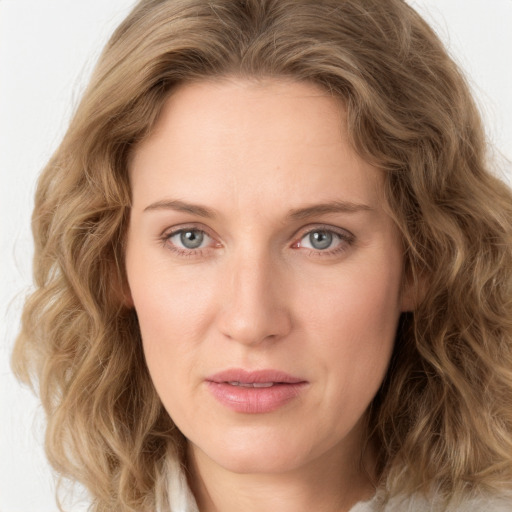 Joyful white young-adult female with long  brown hair and green eyes