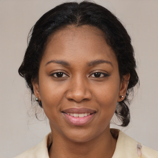 Joyful black young-adult female with medium  brown hair and brown eyes