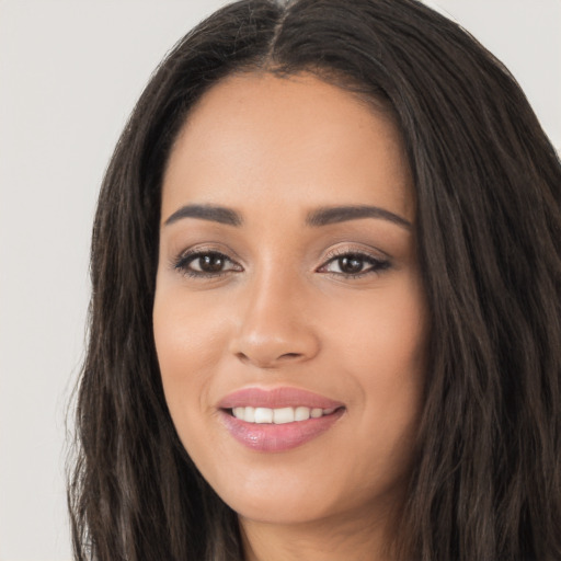 Joyful white young-adult female with long  black hair and brown eyes