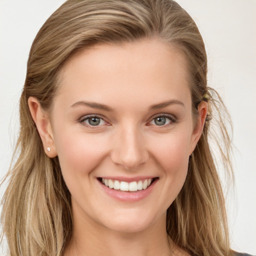 Joyful white young-adult female with long  brown hair and blue eyes