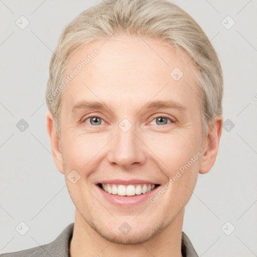 Joyful white adult male with short  brown hair and grey eyes