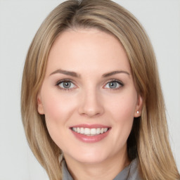 Joyful white young-adult female with long  brown hair and blue eyes