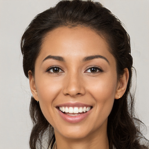 Joyful white young-adult female with long  brown hair and brown eyes