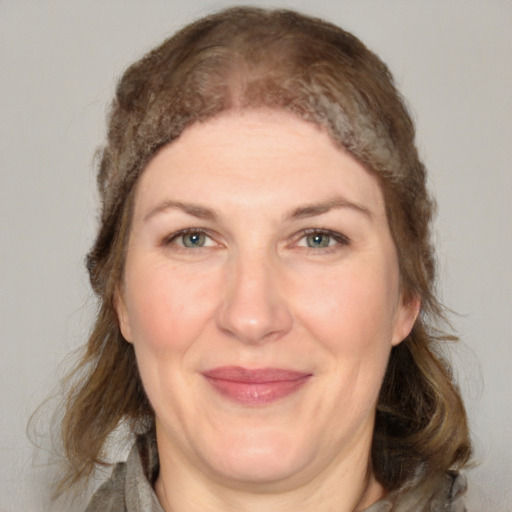 Joyful white adult female with medium  brown hair and grey eyes