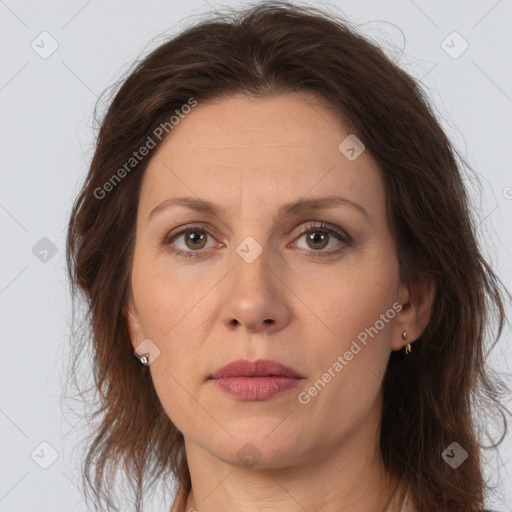 Joyful white adult female with long  brown hair and brown eyes