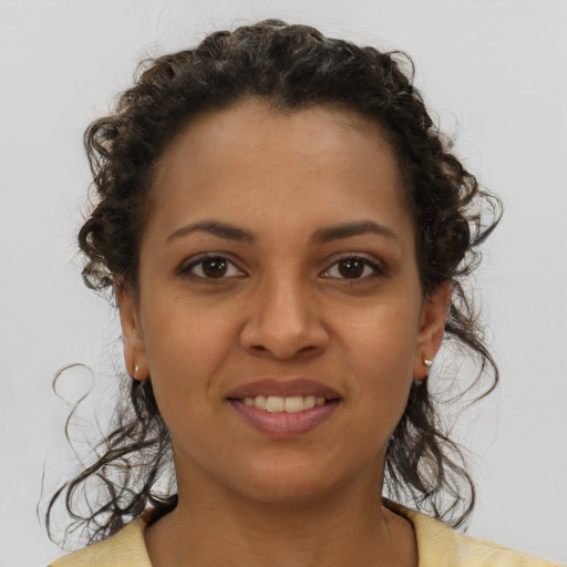 Joyful latino young-adult female with short  brown hair and brown eyes