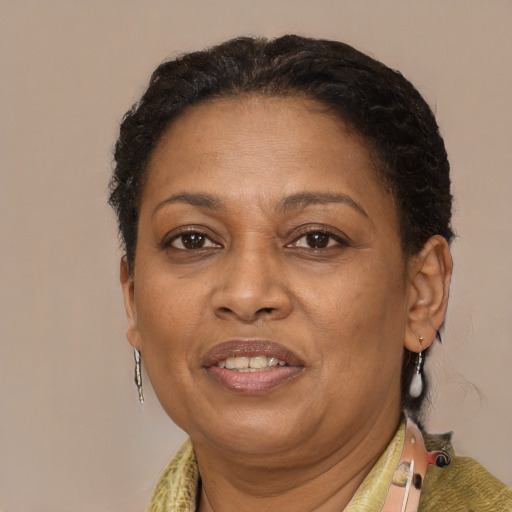 Joyful black adult female with short  brown hair and brown eyes