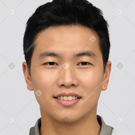 Joyful asian young-adult male with short  black hair and brown eyes