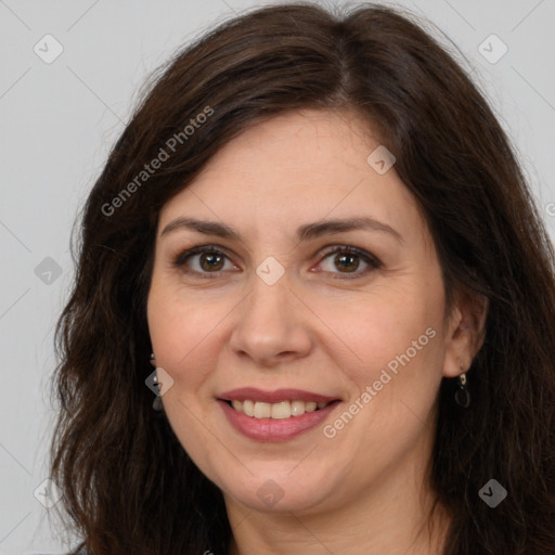 Joyful white adult female with long  brown hair and brown eyes