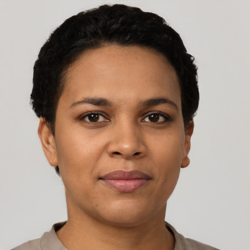Joyful latino young-adult female with short  black hair and brown eyes